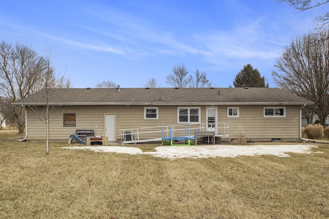 rear view of house featuring a yard