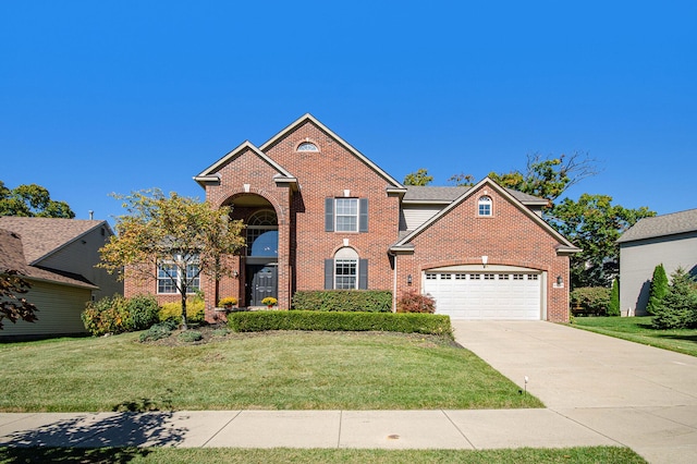 traditional-style house with concrete driveway, a front lawn, an attached garage, and brick siding