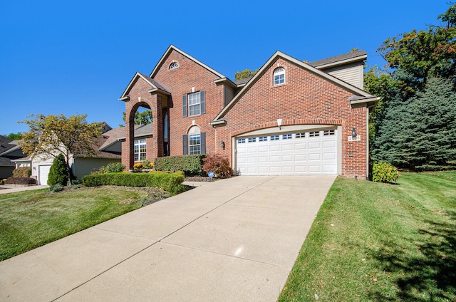 view of front of property with a front lawn, concrete driveway, brick siding, and an attached garage