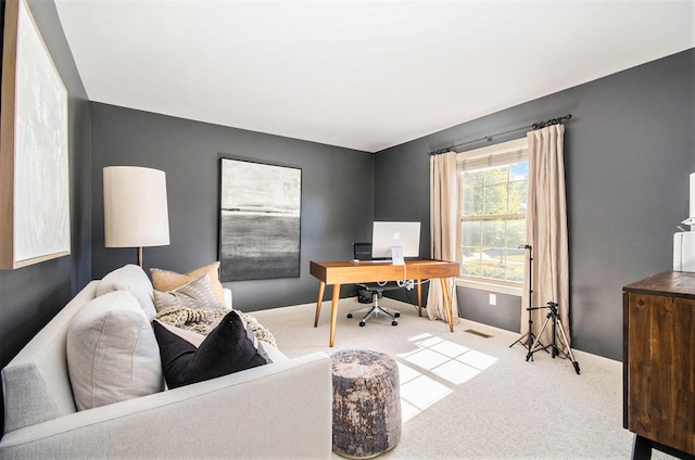 carpeted office featuring visible vents and baseboards