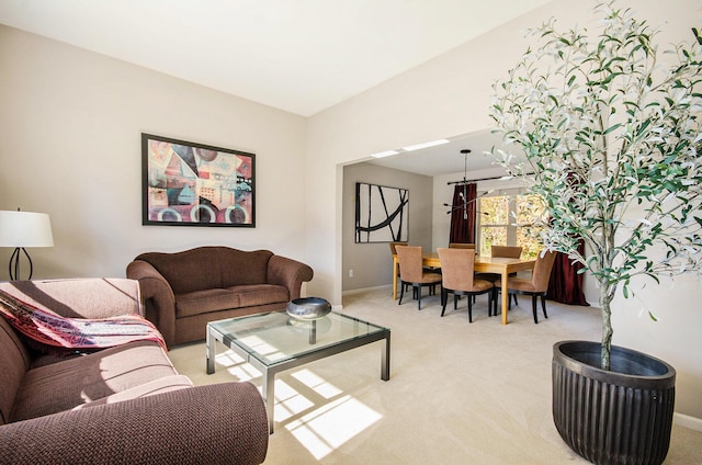 living area featuring baseboards and light colored carpet