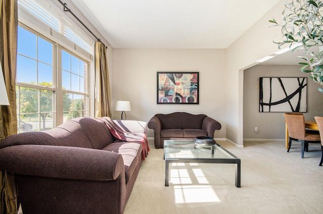 living area featuring carpet floors and baseboards