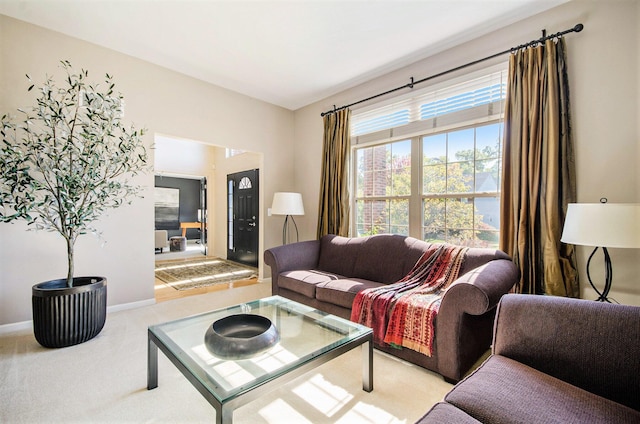 carpeted living room featuring baseboards