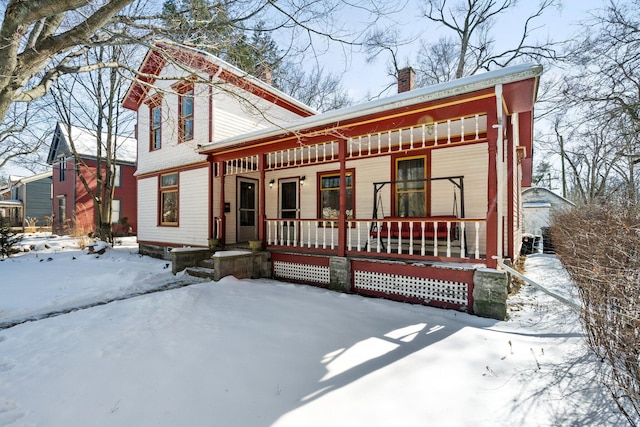 view of front of home with a porch and a chimney