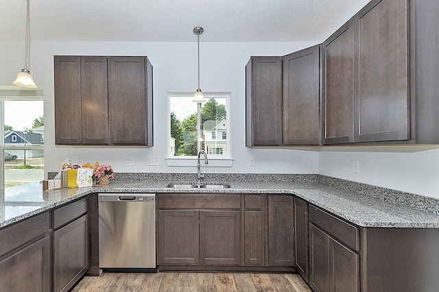 kitchen featuring sink, stainless steel dishwasher, dark brown cabinetry, and light stone counters