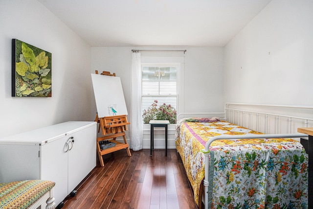 bedroom with dark hardwood / wood-style flooring