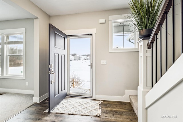 foyer entrance featuring a wealth of natural light, stairway, and baseboards