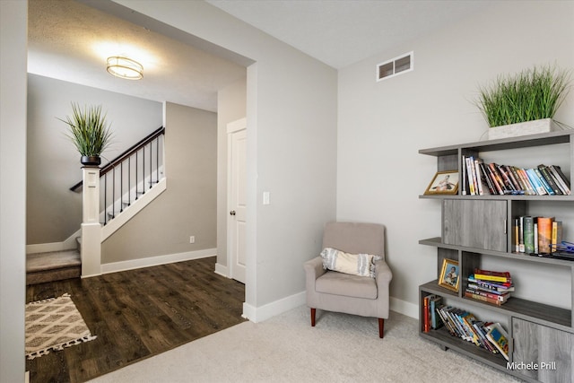 sitting room with carpet, visible vents, stairway, and baseboards