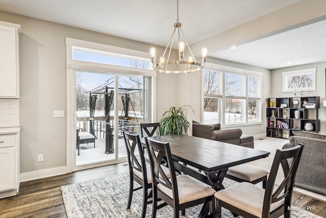 dining room featuring dark wood-style floors, baseboards, a notable chandelier, and recessed lighting