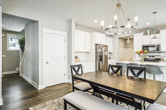 dining space featuring dark wood-style floors, baseboards, a notable chandelier, and recessed lighting