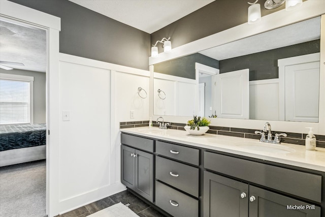 ensuite bathroom with double vanity, a sink, and ensuite bathroom