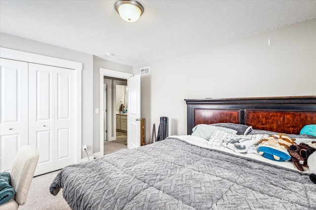 bedroom featuring a closet, light colored carpet, and visible vents