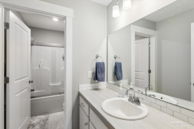 full bathroom with combined bath / shower with glass door and vanity