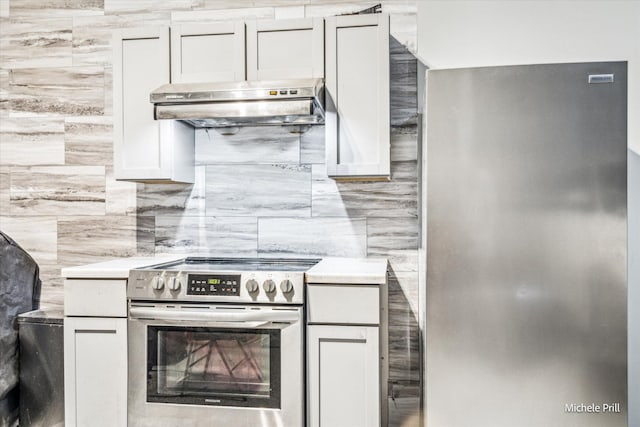 kitchen with light countertops, backsplash, white cabinetry, under cabinet range hood, and stainless steel electric range