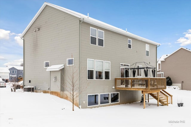 snow covered property featuring stairs, a deck, a gazebo, and central AC unit