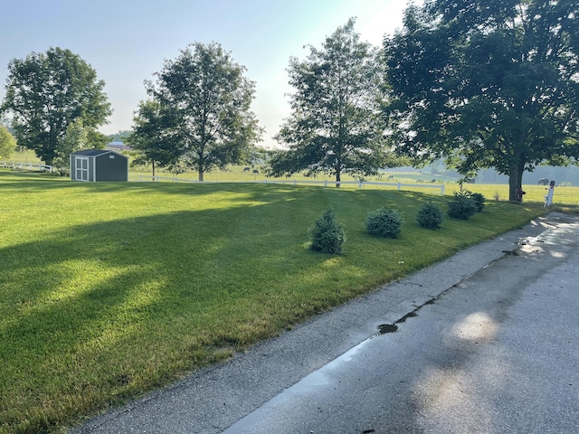 view of yard with an outbuilding and a shed