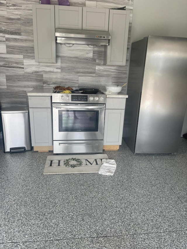 kitchen featuring appliances with stainless steel finishes, ventilation hood, light countertops, gray cabinetry, and backsplash