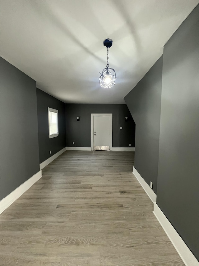 bonus room with light wood-type flooring