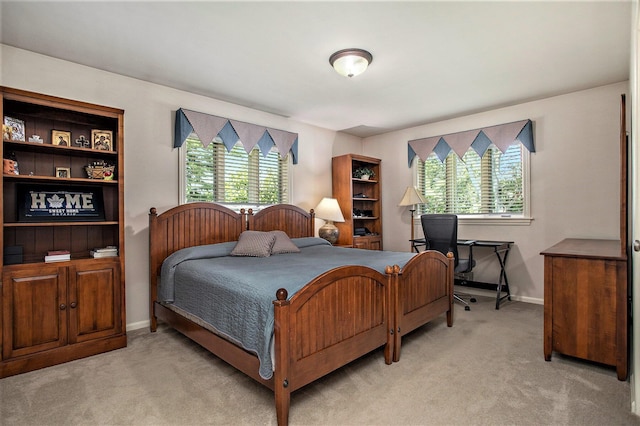 bedroom with light carpet and baseboards