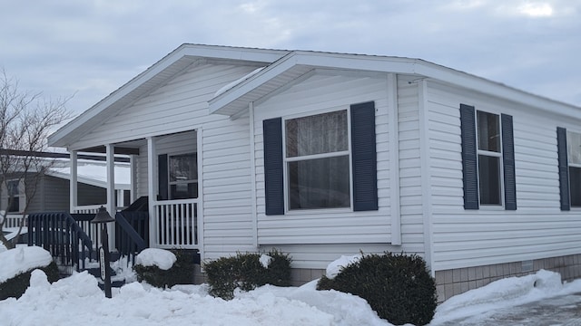 view of snowy exterior with crawl space