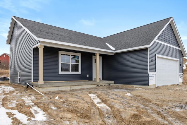 single story home with an attached garage and a shingled roof