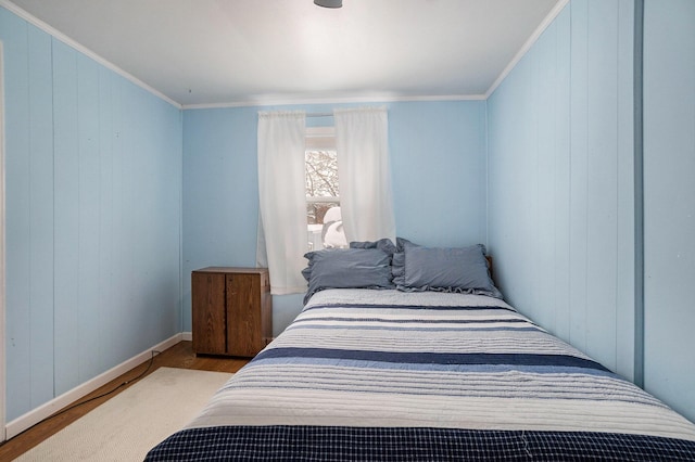 5274 N Bahr Dr Unit 14, Irons, MI 49644 - bedroom with wood finished floors, ornamental molding, baseboards, and wooden walls