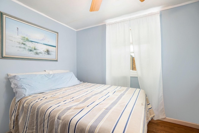 5274 N Bahr Dr Unit 14, Irons, MI 49644 - bedroom featuring wood finished floors, ornamental molding, a ceiling fan, and baseboards