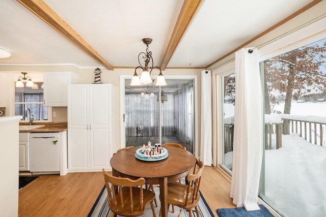 5274 N Bahr Dr Unit 14, Irons, MI 49644 - dining area featuring light wood-style flooring, beamed ceiling, a chandelier, plenty of natural light, and crown molding