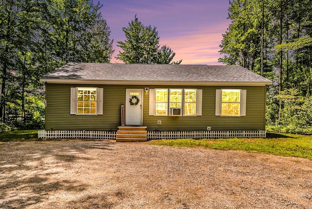 view of front of property with entry steps and a shingled roof