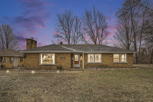 single story home featuring a yard