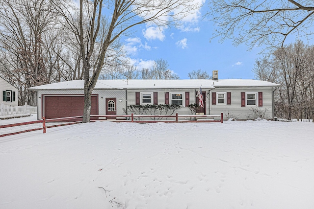 view of front of house with a fenced front yard and an attached garage