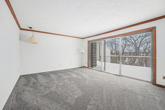 carpeted spare room featuring ornamental molding, a textured ceiling, and baseboards