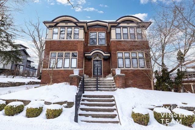 view of front of house featuring a garage and brick siding