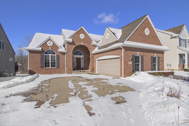 view of front of home featuring a garage and brick siding