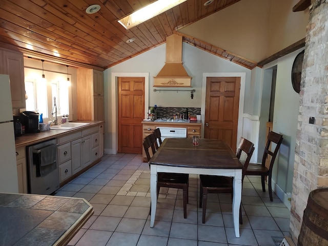 kitchen with dishwashing machine, vaulted ceiling with skylight, wooden ceiling, premium range hood, and freestanding refrigerator