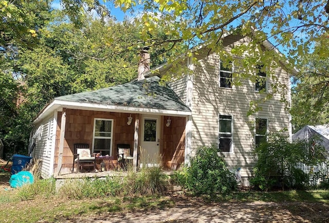 view of front of house featuring a chimney