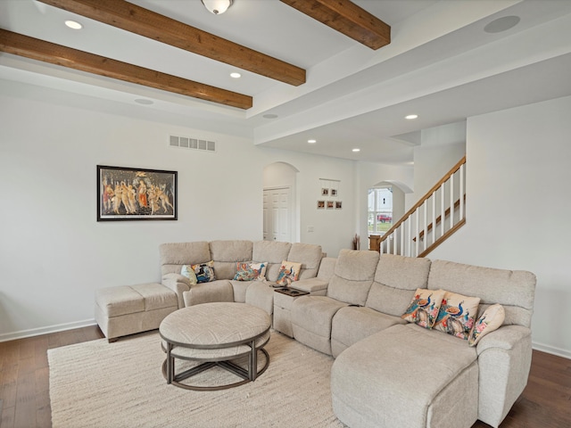 living room with arched walkways, recessed lighting, dark wood-style flooring, visible vents, and baseboards