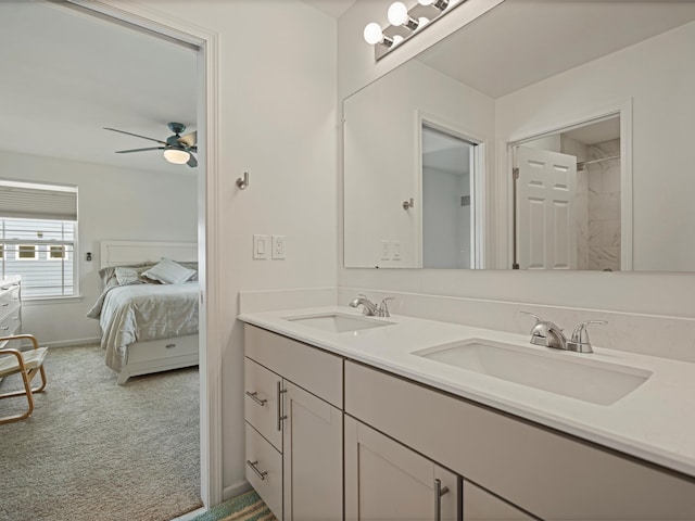 full bathroom featuring connected bathroom, double vanity, a sink, and a ceiling fan