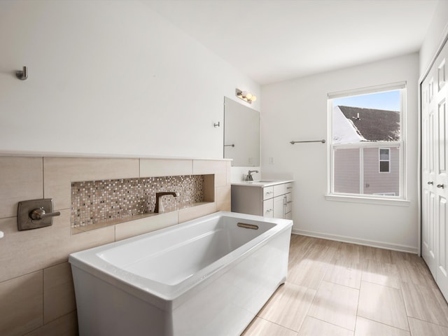 bathroom featuring a tub to relax in and vanity