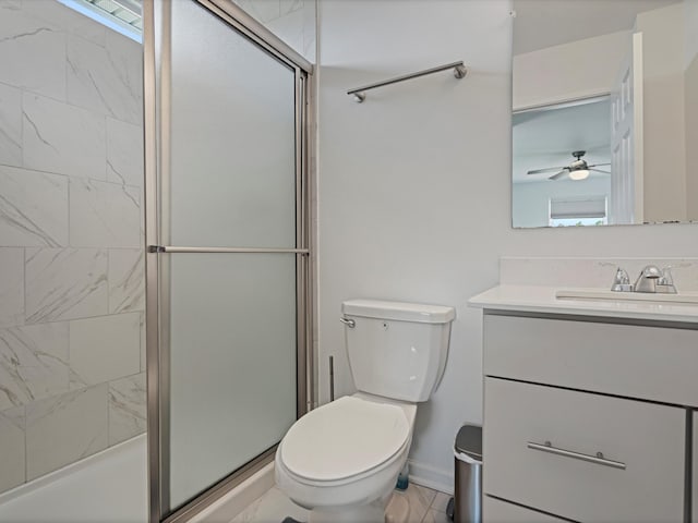 bathroom with toilet, vanity, baseboards, marble finish floor, and a shower with door