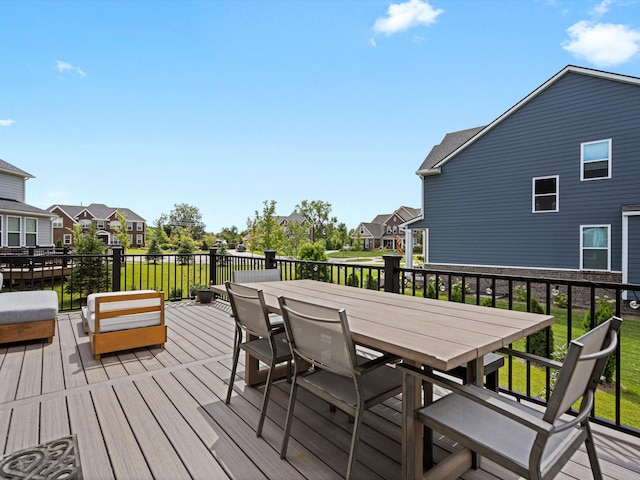 wooden deck with a residential view and outdoor dining space