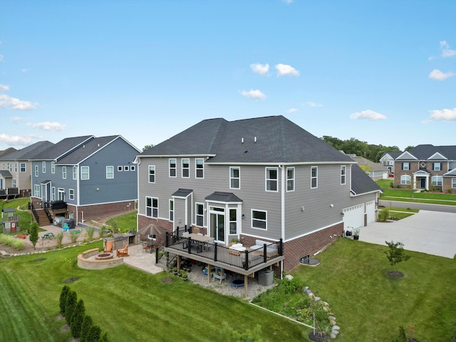 rear view of house with a residential view, brick siding, driveway, and an outdoor fire pit