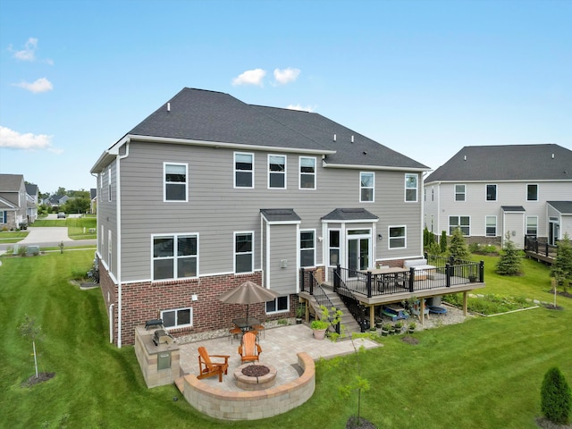 back of house with a fire pit, a residential view, stairway, a deck, and brick siding