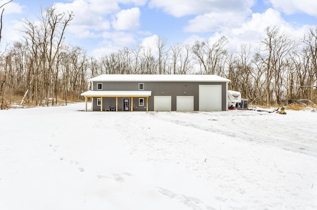 exterior space featuring covered porch and a detached garage