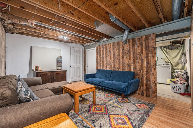 living room featuring wood finished floors and washer / dryer