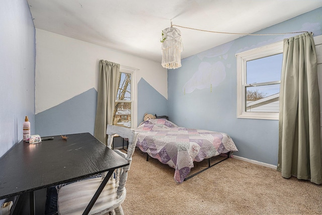 bedroom featuring a chandelier, carpet, and baseboards