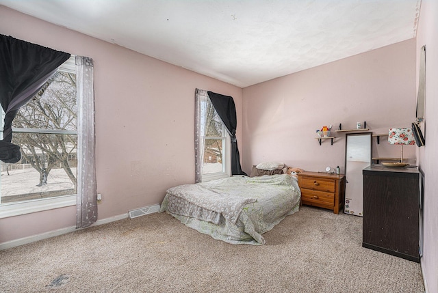 carpeted bedroom with baseboards and visible vents