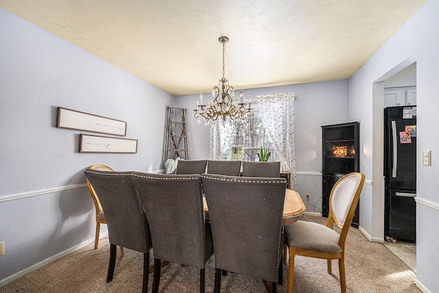 dining space with baseboards, a chandelier, and carpet flooring