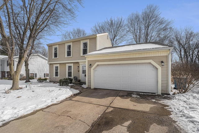 colonial inspired home featuring a garage and driveway