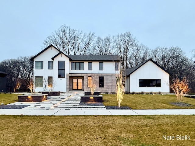 rear view of property with a lawn